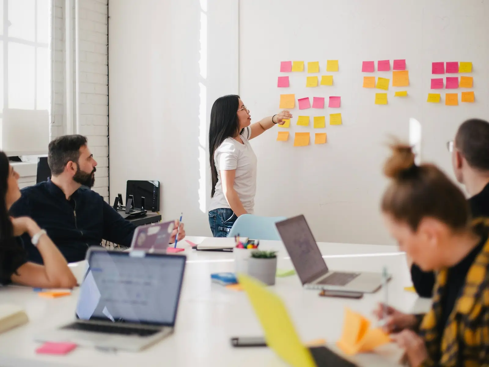 A team working through ideas on sticky notes in a workshop