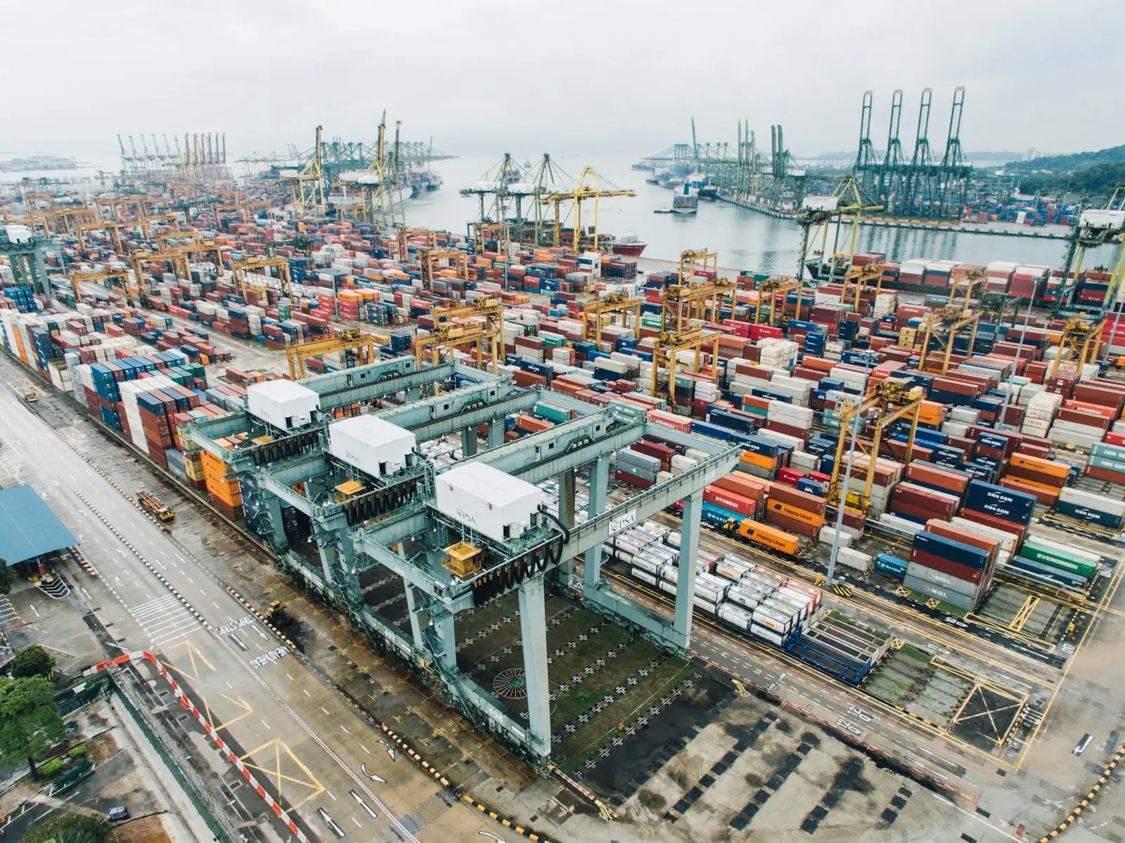 Aerial view of a container port with cranes and stacked containers